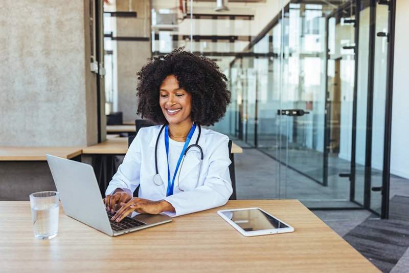 medical professional working on a laptop in an office